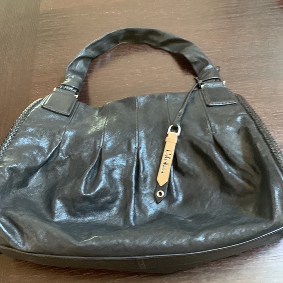 Black leather satchel with 4 zipped compartments.